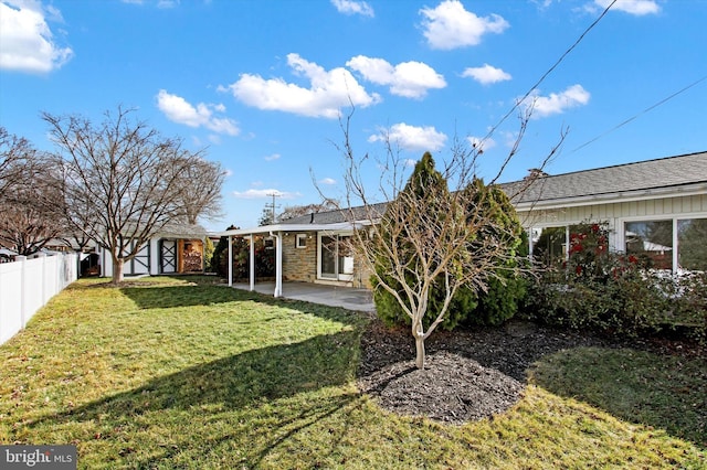 back of house with a storage shed, a yard, and a patio area