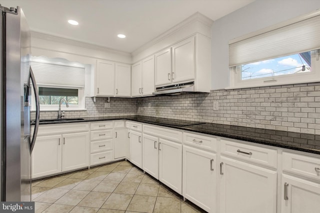 kitchen featuring white cabinetry, sink, black electric cooktop, and stainless steel fridge with ice dispenser