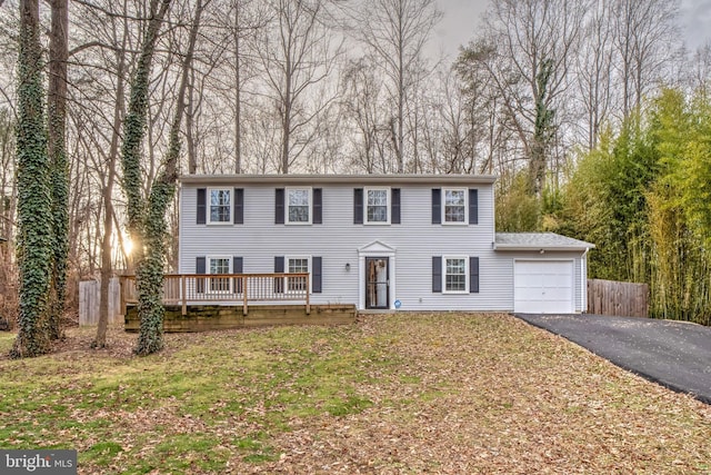 colonial home with a garage and a front yard