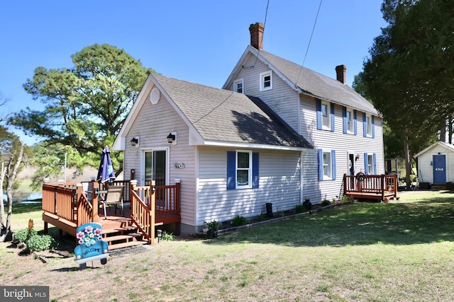 back of house featuring a yard and a deck