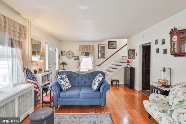 living room featuring hardwood / wood-style flooring and radiator heating unit