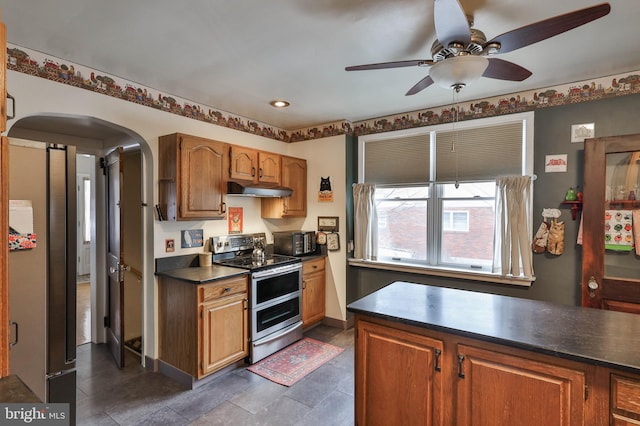 kitchen featuring ceiling fan and range with two ovens