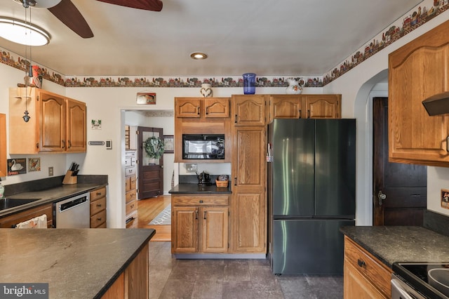 kitchen with ceiling fan, appliances with stainless steel finishes, sink, and exhaust hood