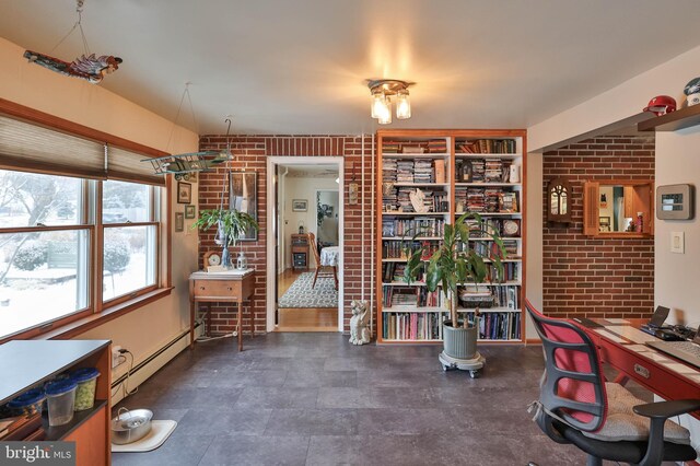 office featuring baseboard heating and brick wall