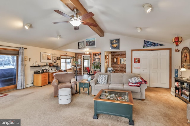 carpeted living room with ceiling fan and lofted ceiling with beams