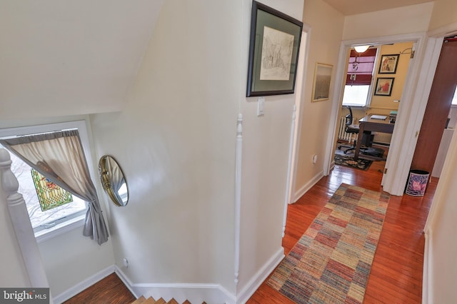 corridor with wood-type flooring and plenty of natural light