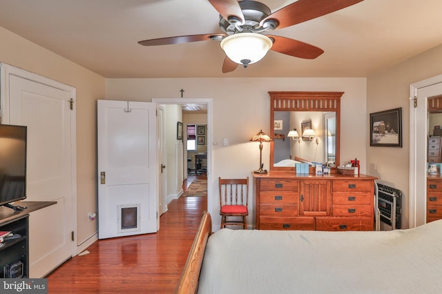 bedroom with dark hardwood / wood-style floors and heating unit