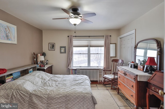 bedroom featuring radiator and ceiling fan