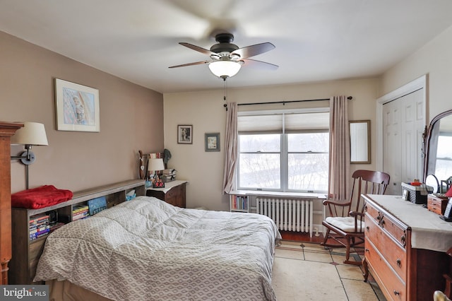 bedroom featuring radiator heating unit and ceiling fan