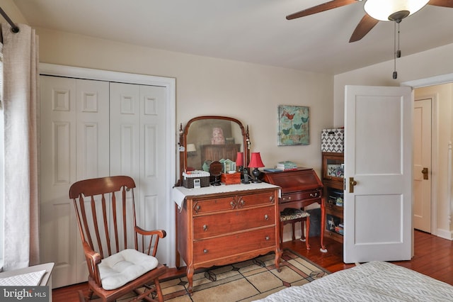 bedroom with wood-type flooring, ceiling fan, and a closet