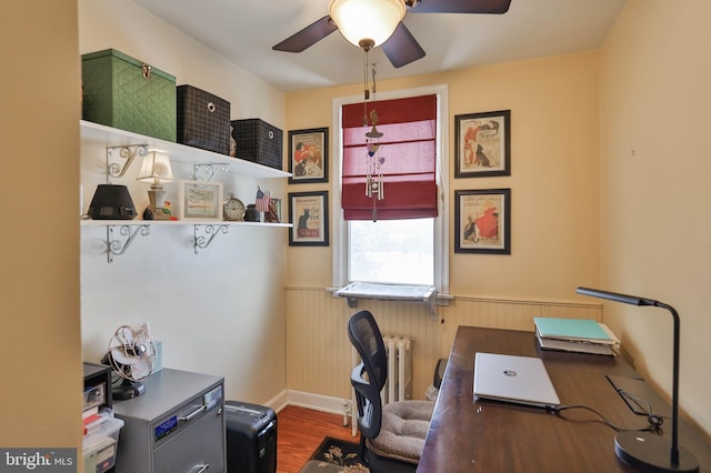 office space with hardwood / wood-style floors, radiator, and ceiling fan