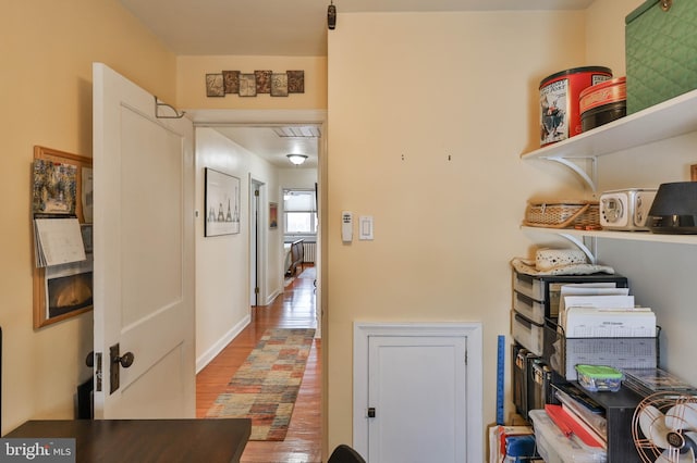 corridor featuring hardwood / wood-style floors