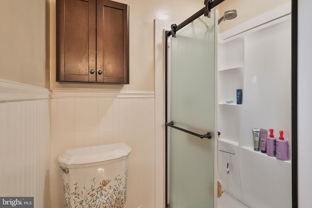 bathroom featuring a shower with door