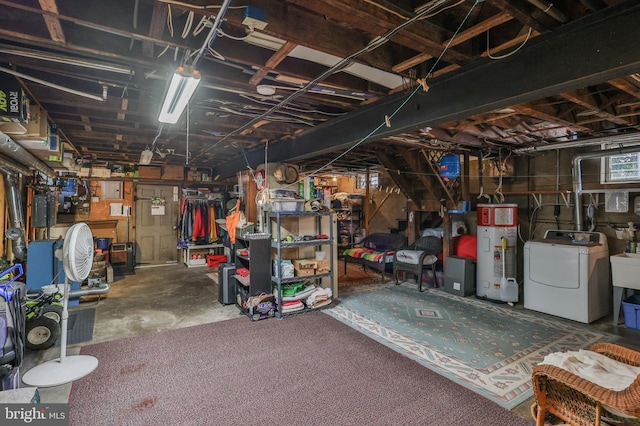 basement with water heater and washer / dryer