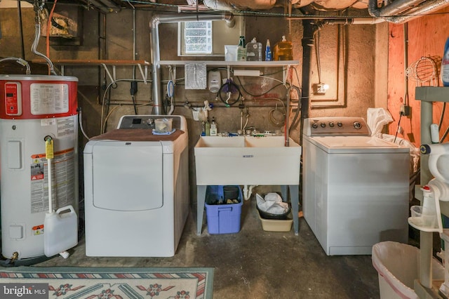 washroom featuring washer and dryer, sink, and water heater