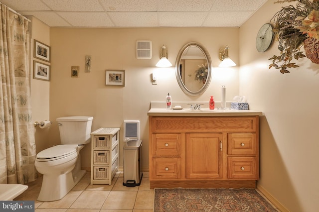 bathroom with vanity, tile patterned flooring, a paneled ceiling, and toilet