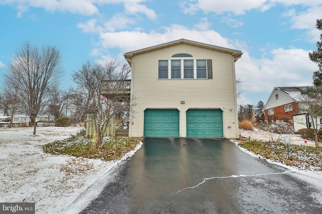 view of snowy exterior with a garage