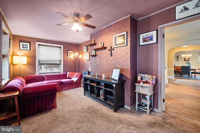 cinema featuring ornamental molding, carpet flooring, and ceiling fan with notable chandelier