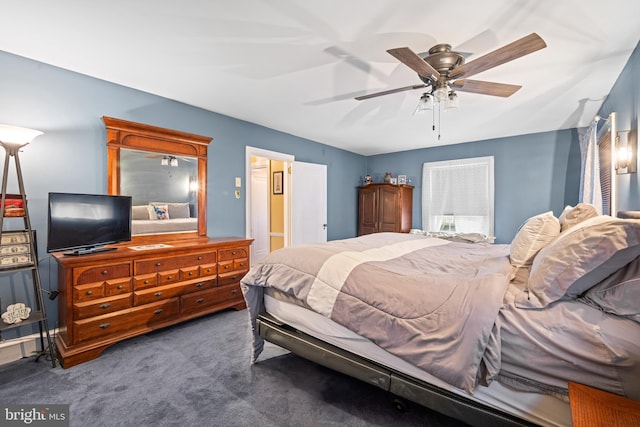 bedroom with dark carpet and ceiling fan