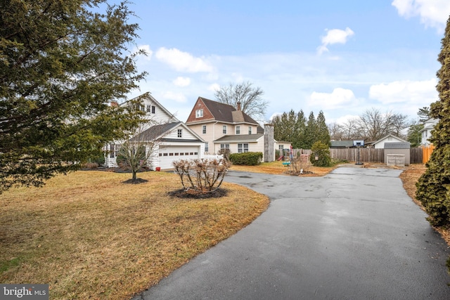 view of front of property featuring a garage and a front yard