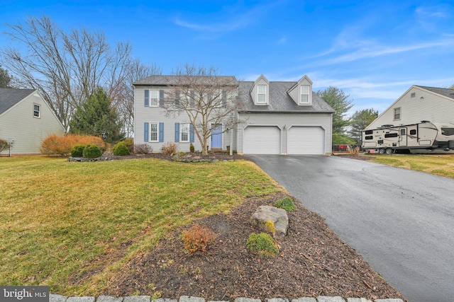 view of front of property with aphalt driveway, a front yard, and an attached garage