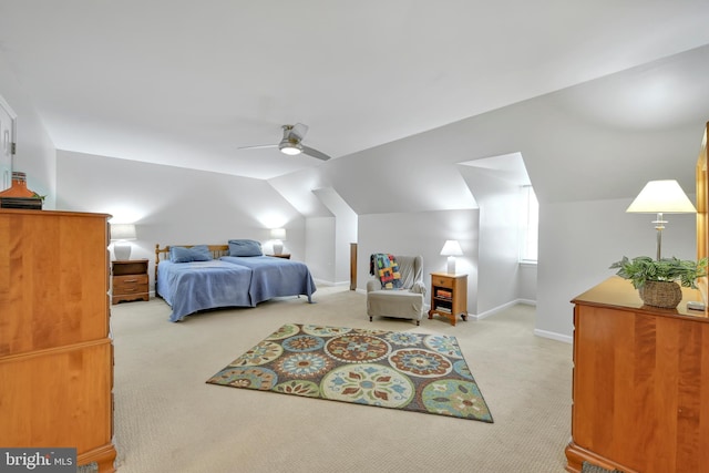 bedroom featuring lofted ceiling, ceiling fan, baseboards, and light colored carpet