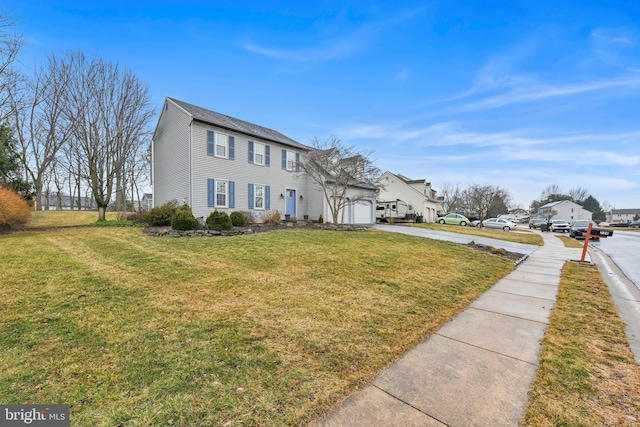 view of front of house featuring driveway, an attached garage, and a front yard