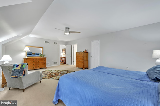 bedroom with visible vents, vaulted ceiling, and light colored carpet