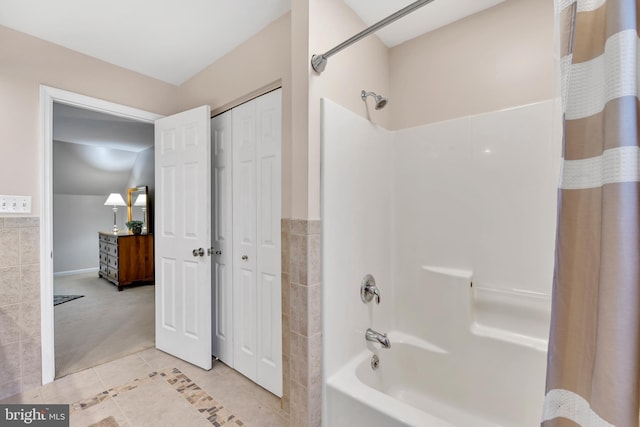 bathroom featuring shower / bath combination with curtain, tile patterned flooring, and a closet