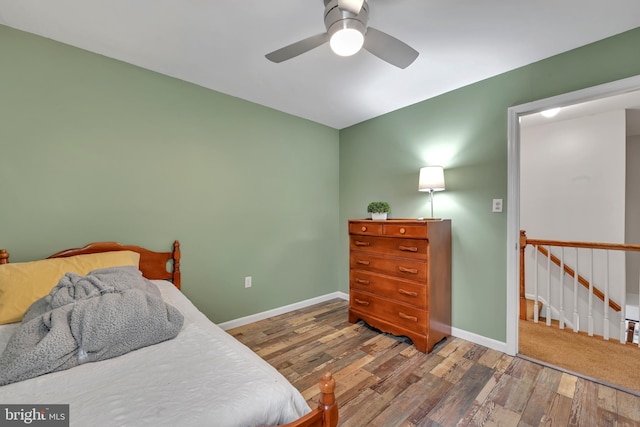 bedroom featuring ceiling fan, wood finished floors, and baseboards