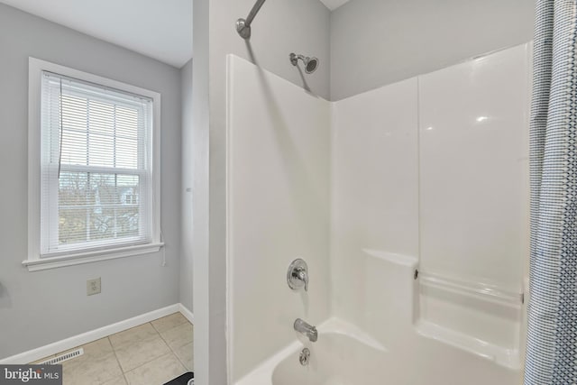 full bathroom with visible vents, shower / bath combo, baseboards, and tile patterned floors