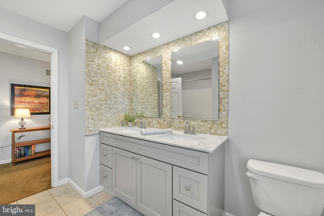 full bath with toilet, tile patterned flooring, a sink, and recessed lighting