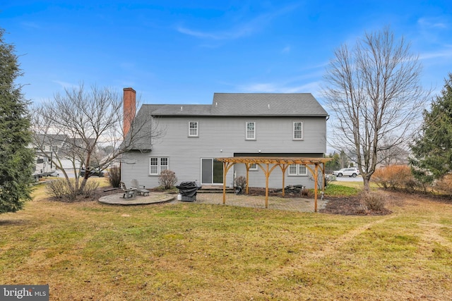 rear view of house featuring a chimney, a pergola, a lawn, and a patio