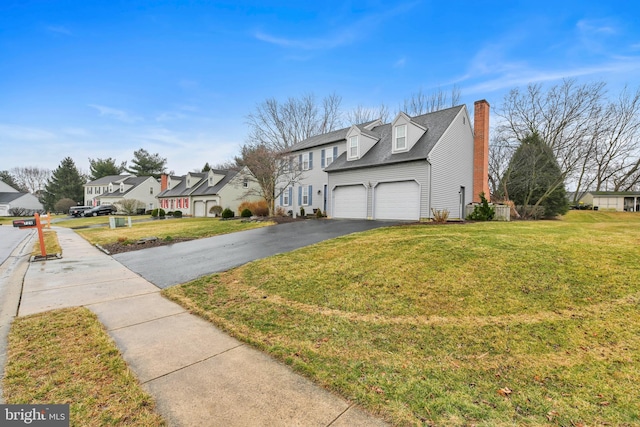 view of home's exterior featuring an attached garage, driveway, a lawn, a residential view, and a chimney