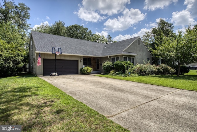 ranch-style house featuring a garage and a front lawn