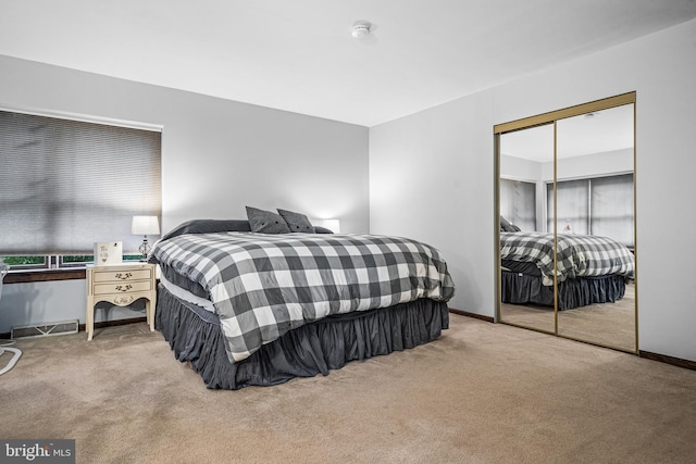 bedroom with a closet and light carpet