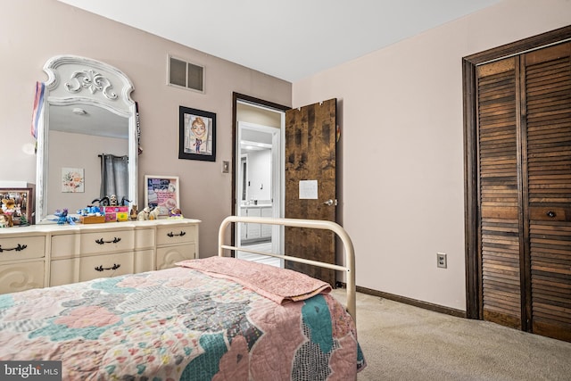 bedroom featuring light colored carpet and a closet