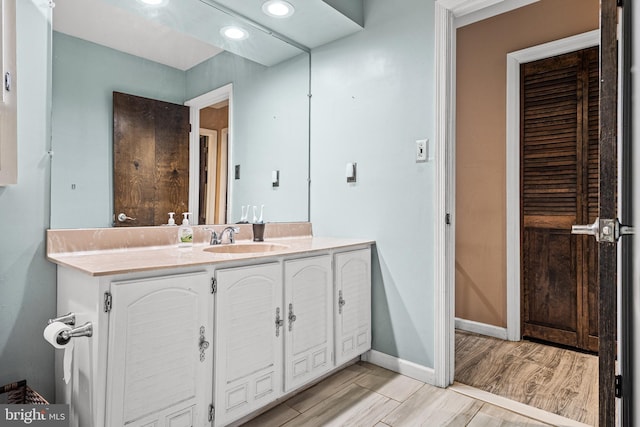 bathroom featuring wood-type flooring and vanity