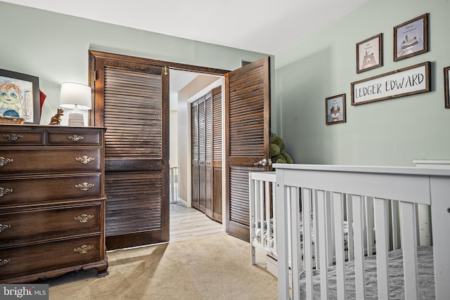 bedroom featuring light carpet and a closet