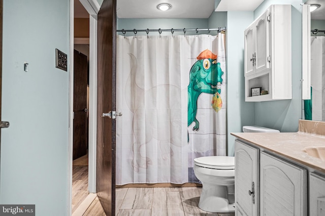 bathroom with vanity, a shower with curtain, and toilet