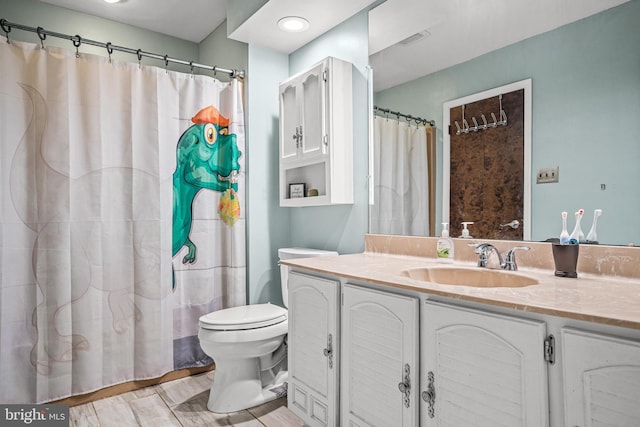 bathroom featuring vanity and toilet