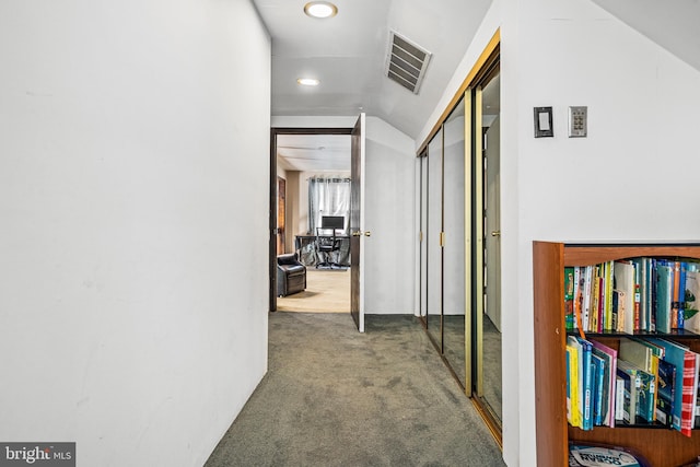 hallway featuring vaulted ceiling and carpet floors