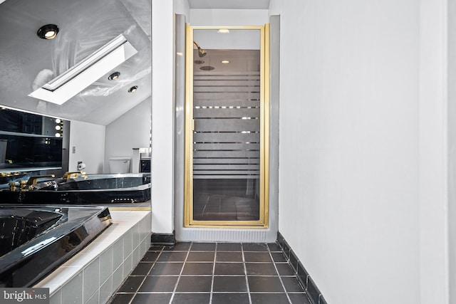 bathroom with an enclosed shower, tile patterned flooring, lofted ceiling with skylight, and toilet