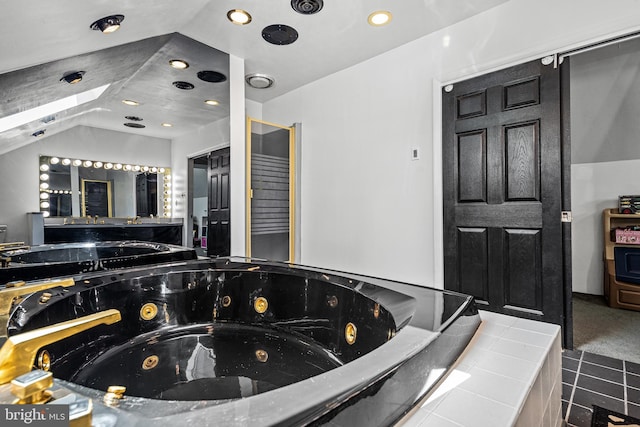 bathroom with tiled bath and vaulted ceiling