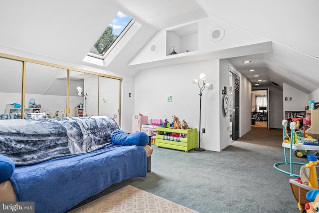 bedroom featuring a closet, lofted ceiling with skylight, and carpet