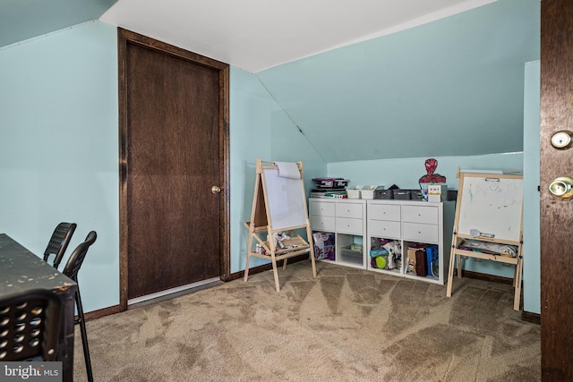 interior space featuring vaulted ceiling and carpet