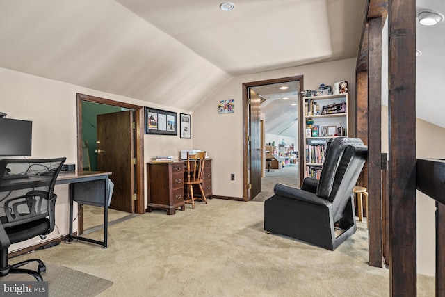 office with lofted ceiling and light colored carpet