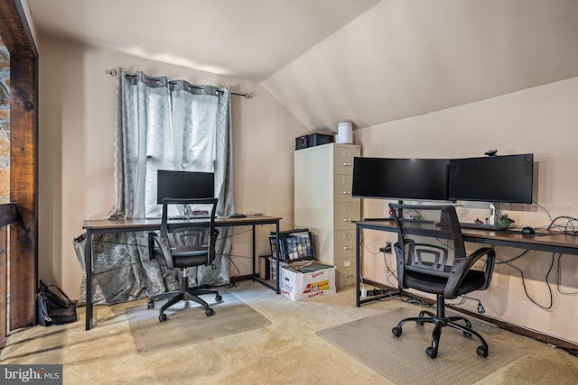 carpeted office space featuring vaulted ceiling