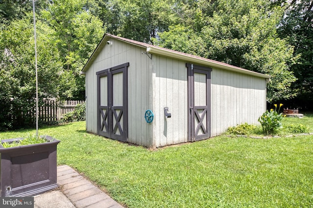 view of outdoor structure with a lawn