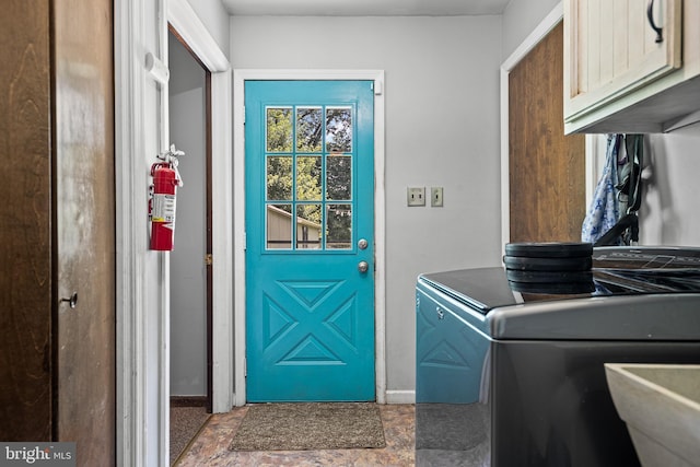 laundry room with cabinets, washer / dryer, and sink